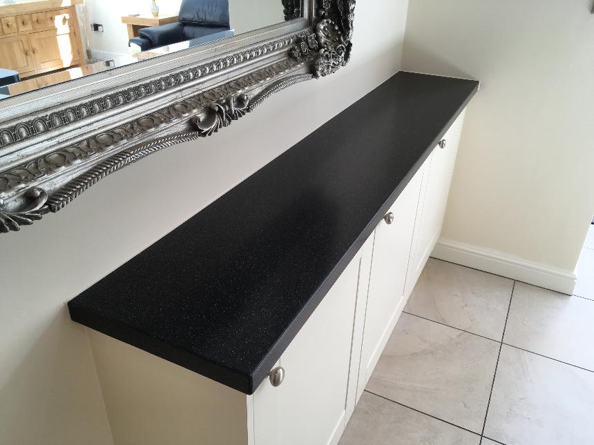 DuPont Corian deep black quartz deep colour technology island breakfast bar drop down slab waterfall end corian avante sinks instant boiling water tap coved splashback solid surface kitchen worktops