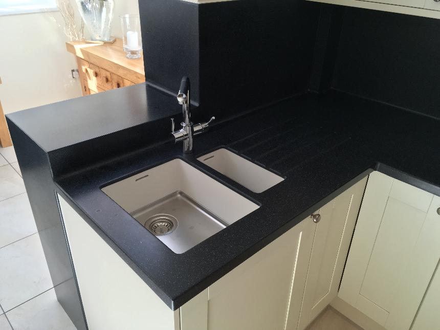 DuPont Corian deep black quartz deep colour technology island breakfast bar drop down slab waterfall end corian avante sinks instant boiling water tap coved splashback solid surface kitchen worktops